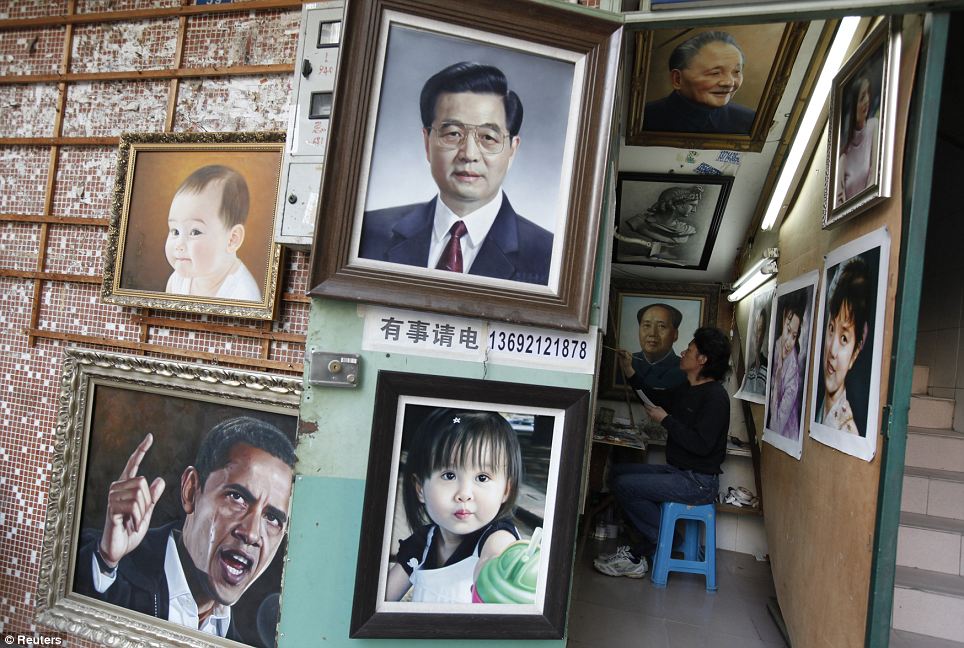 A painter works on an oil painting next to a portrait of China