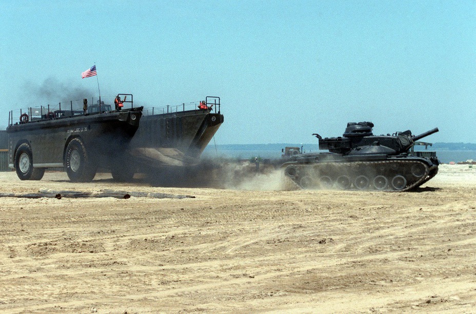 ​Основной танк М60А2 покидает грузовую площадку американского армейского тяжёлого плавающего транспортёра LARC-LX. В эксплуатации с 1952 года. Масса 100 тонн, 4 двигателя по 265 л.с. Скорость по суше до 25 км/ч, по воде до 12 км/ч. Экипаж 5 человек. Грузоподъёмность до 100 тонн или 200 человек десанта - Армейские земноводные 